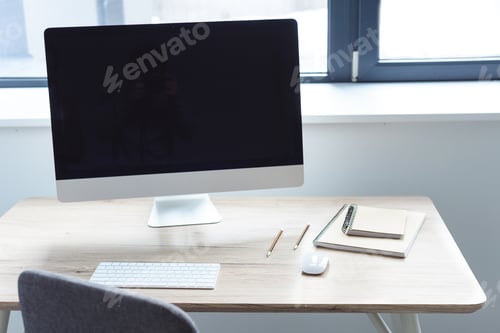 Preview: Computer with blank monitor on working table