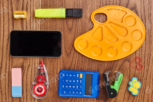 Preview: Desk with school supplies against wooden background.