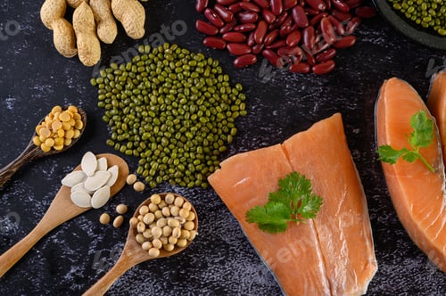 Preview: Legumes and salmon placed on a black cement floor.