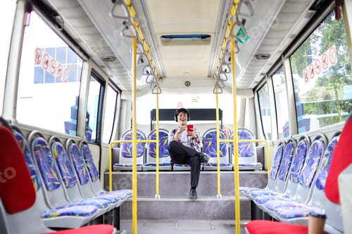 Preview: Young Asian Guy Using Mobile Phone, Laughing While Watching Funny Videos at City Bus