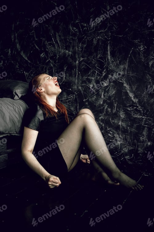 Preview: Young woman sitting on floor and crying aloud. Depression, despair. Mental health.