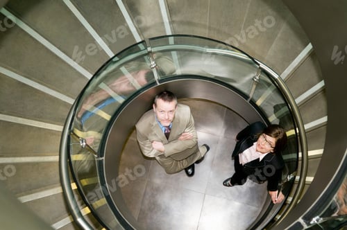 Preview: Business couple in a spiral stairwell