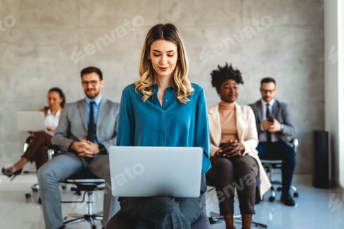 Preview: Group of young business people working as a team and communicating in corporate office