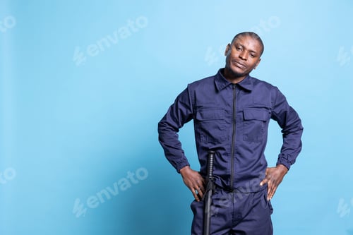 Preview: Security agent showing his authority by standing with hands on hips
