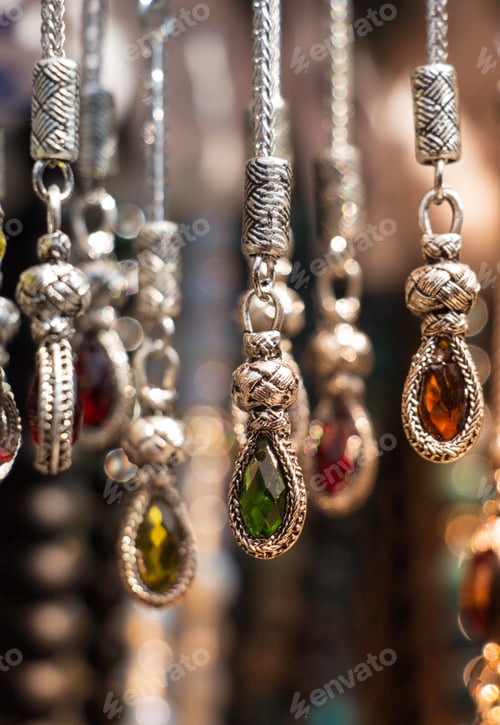 Preview: Vertical of hanging necklaces with colorful precious jewels