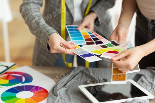 Preview: Fashion designer choosing color samples in atelier