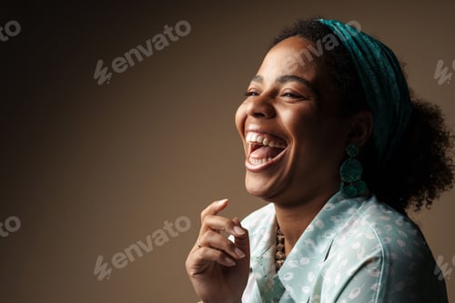 Preview: Young black woman in headband laughing and looking aside