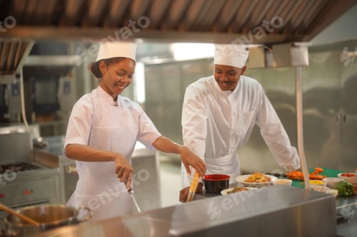 Preview: Chefs preparing dishes together in a busy kitchen during a culinary training session