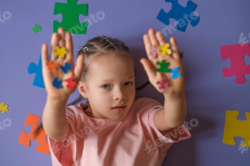 Preview: A lonely girl on purple background shows pieces of colorful puzzles with arms outstretched.