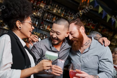 Preview: bearded men and african american woman laughing in cocktail bar, leisure of multiethnic colleagues