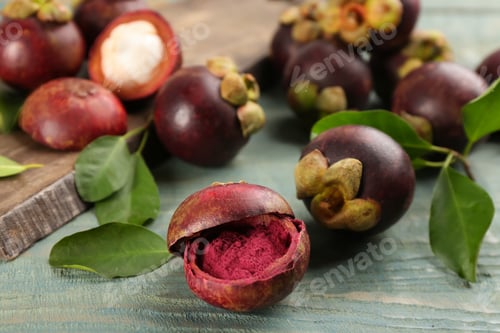 Preview: Purple mangosteen powder and fruits on light blue wooden table