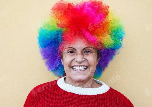 Preview: Happy senior woman with colorful wig - Crazy grandmother