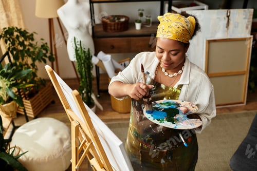 Preview: Creative inspiration flows as a beautiful woman crafts a masterpiece in a vibrant workshop