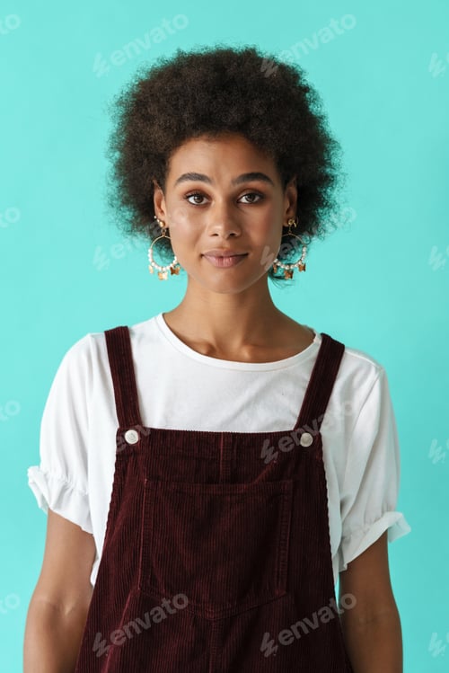 Preview: Black young woman in earrings posing and looking at camera
