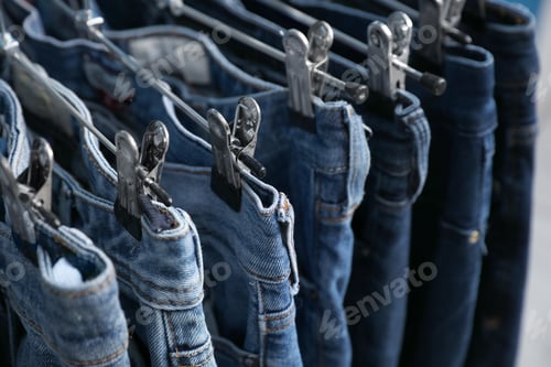 Preview: Metal hangers with different stylish jeans, closeup