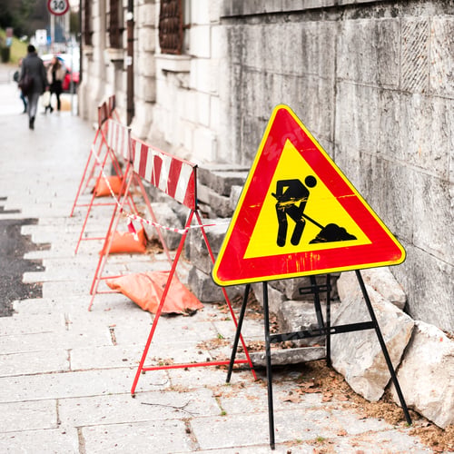 Preview: Construction zone sign by the road in urban environment