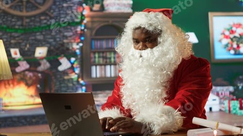 Preview: Black Santa searches online for gift locations using his laptop