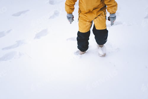 Preview: A joyful child playing in fresh snow during winter's frosty embrace