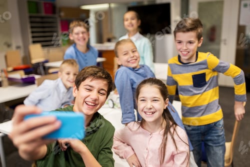 Preview: group of school kids taking selfie with smartphone