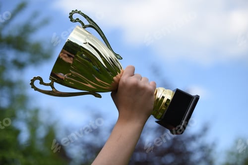 Preview: Cup in the hand of a teenager against the blue sky