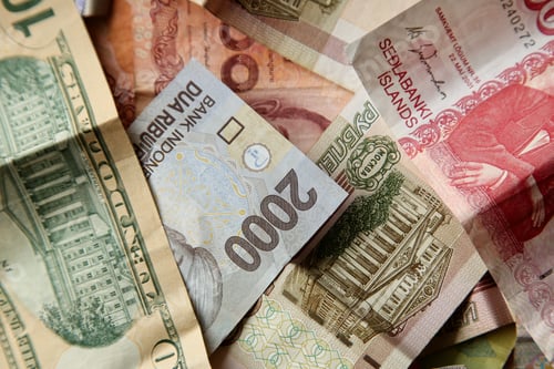 Preview: High angle closeup shot of pile of banknotes on wooden surface