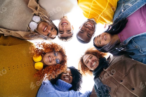 Preview: Circle of Diverse Smiling Friends Looking Down at Camera