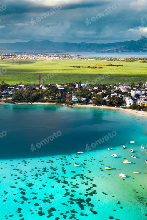Preview: Top view of the Blue Bay lagoon of Mauritius. A boat floats on a turquoise lagoon