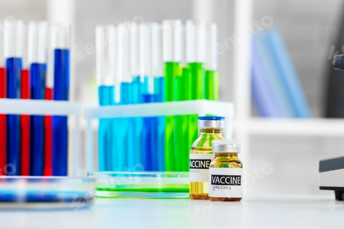 Preview: Vaccine in vial for injection on table against background of laboratory