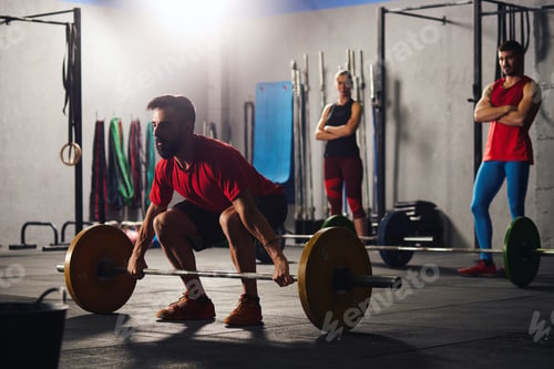 Preview: Man squatting and lifting a barbell.