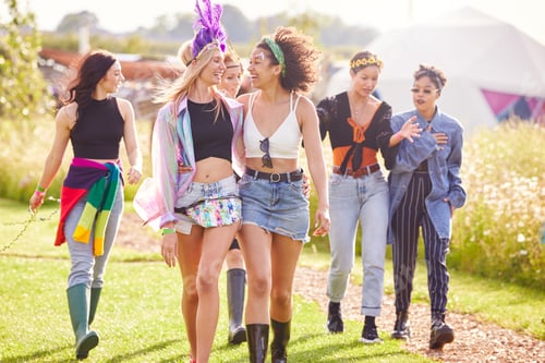 Preview: Female Friends Walking Back To Tent After Outdoor Music Festival