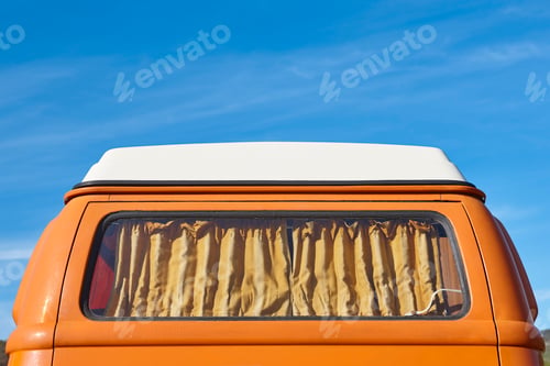 Preview: Vintage camper van under a blue sky. Recreational vehicle. Summertime