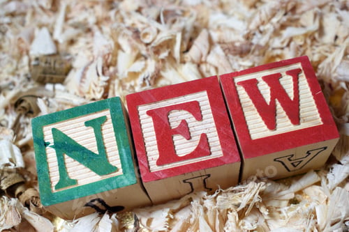 Preview: Closeup of the word New arranged with wooden blocks