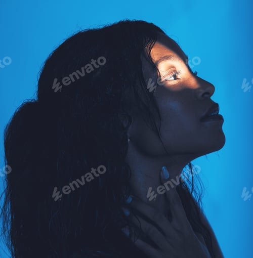 Preview: Spotlight, model and woman for skincare, face and cosmetics with blue studio background. Makeup, na