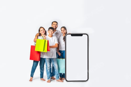 Preview: asian Indian family promoting sale offer standing with big tall smartphone cutout