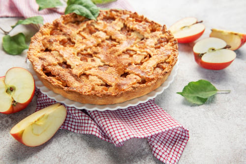 Preview: Delicious homemade apple pie decorated with fresh apple slices and leaves