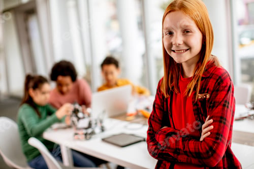 Preview: Cute little girl standing in front of group of kids programming