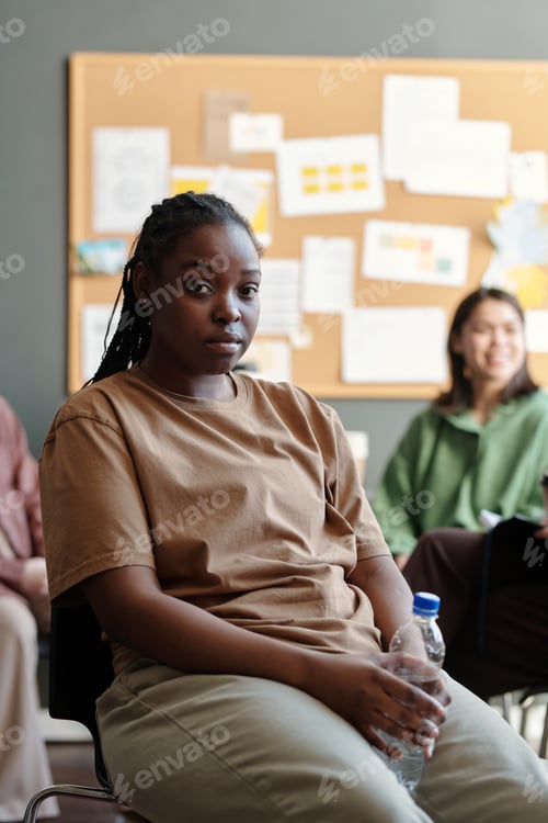 Preview: Young upset woman with bottle of water