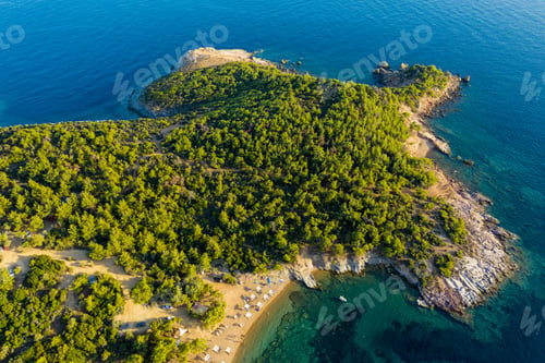 Preview: Aerial drone view of beach umbrellas and sunbeds on the coast in Thassos island, Greece