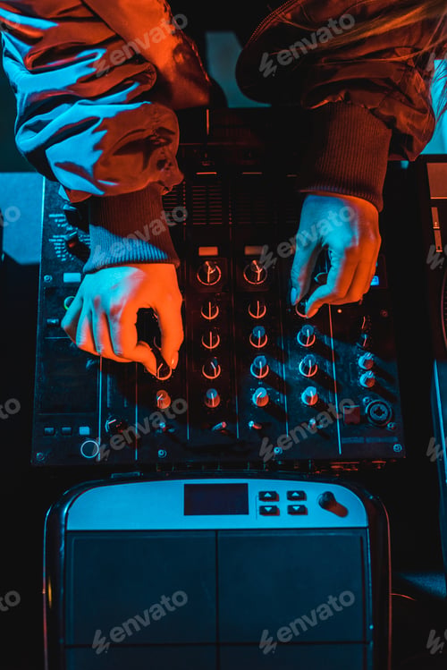 Preview: top view of dj woman touching dj mixer in nightclub
