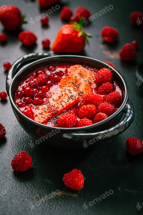 Preview: Breakfast red smoothie bowl with chia seeds, strawberry, raspberry and redcurrants