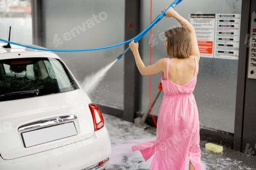 Preview: Cute woman washes her vehicle at self-service car wash