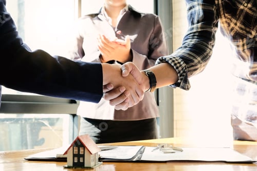Preview: Real estate agent and customers shaking hands together celebrating finished contract after about