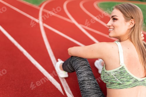 Preview: Sports woman sits on the stadium track