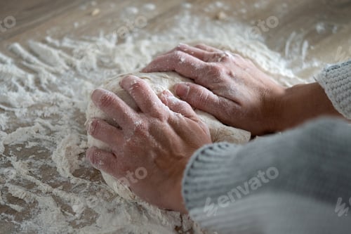 Preview: Woman kneading dough in kitchen preparing homemade bread