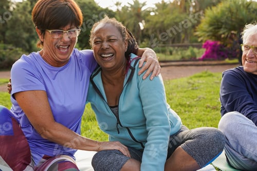 Preview: Happy multiracial senior women having fun together after sport workout at city park