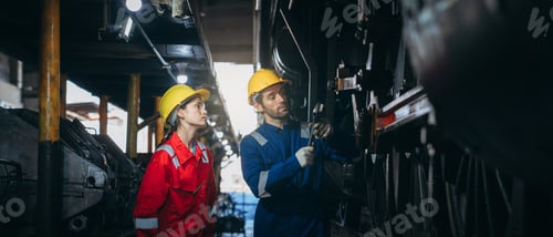 Preview: Industrial engineers inspect and perform maintenance on the machines at factory machines.