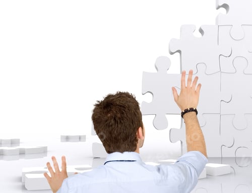 Preview: Business Man Building A Puzzle Isolated Over White
