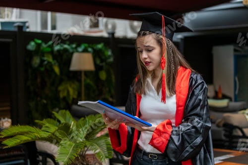 Preview: Young student wears cape and and looking at her notes