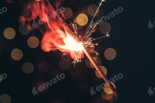 Preview: Red bengal sparkle lights close up on dark background