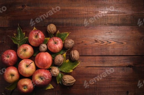 Preview: Apples and Walnuts on a Rustic Wooden Background